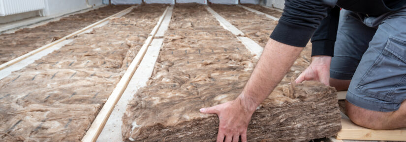 Man insulating the attic with rock wool.